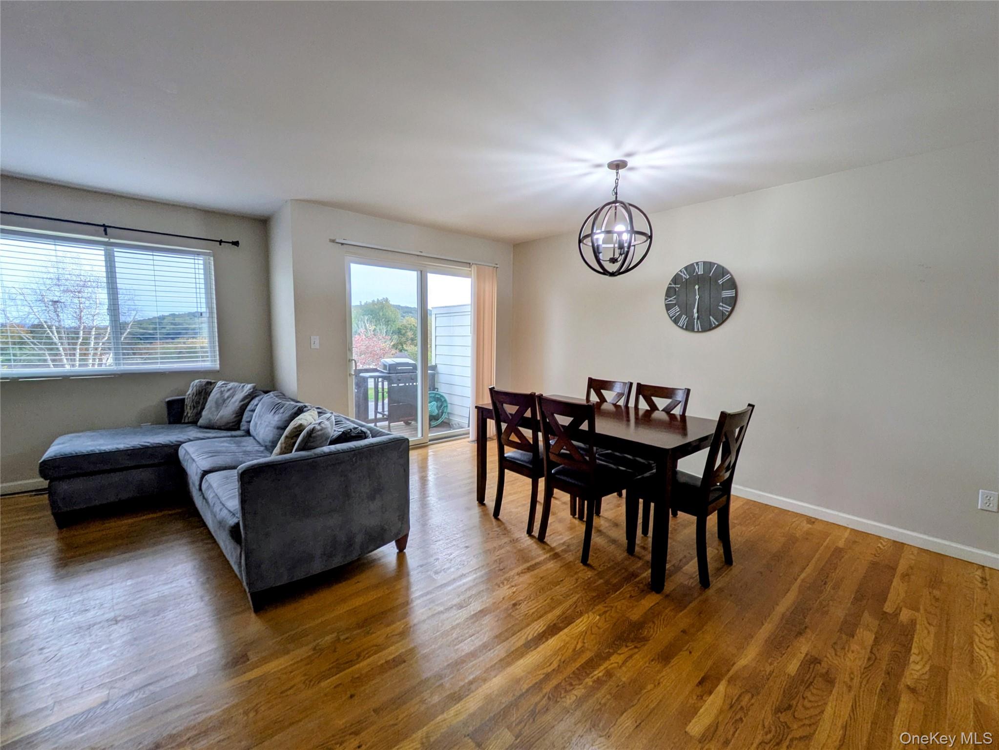1206 Eagles Ridge Road Brewster, NY 10509 - Photo 5 of 29 Dining room with light wood-style floors and a chandelier