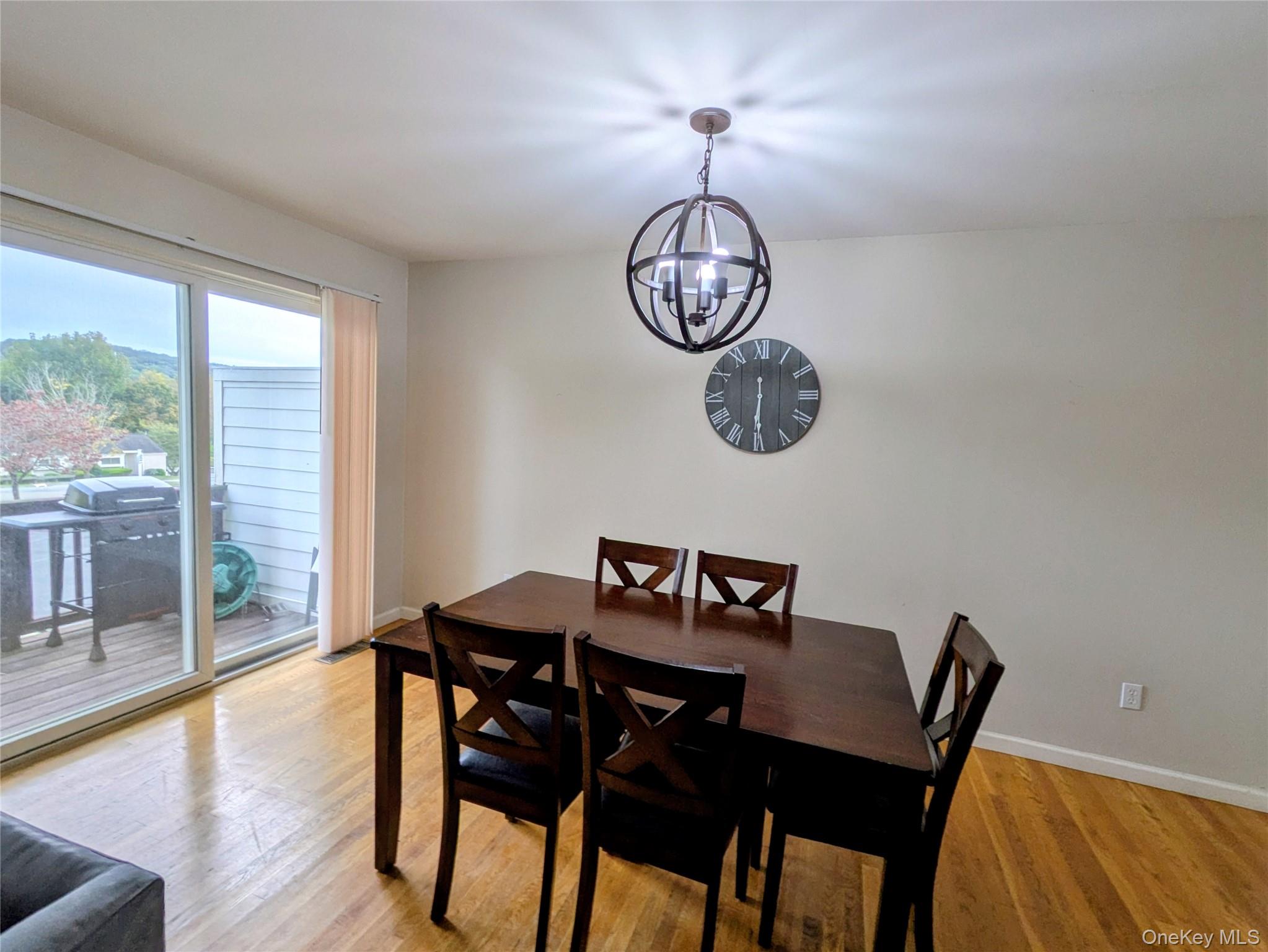 1206 Eagles Ridge Road Brewster, NY 10509 - Photo 9 of 29 Dining room featuring light wood-type flooring and a chandelier