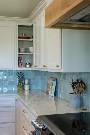 a kitchen with white cabinets and a sink