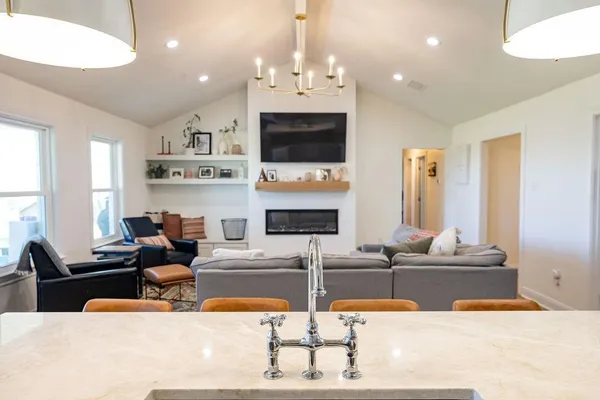 a living room with fireplace furniture and a flat screen tv