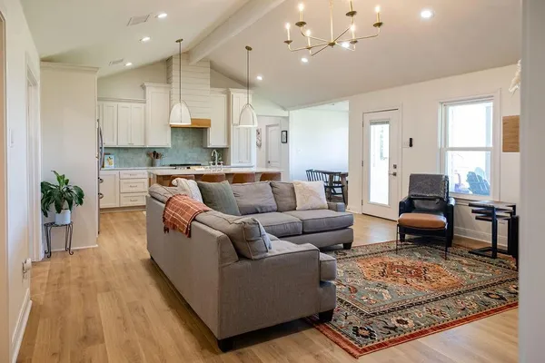 a living room with furniture wooden floor and a window