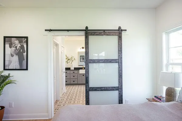 a bedroom with a bed and wooden floor