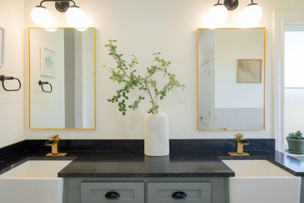 1132 Old Crawford Road Crawford, TX 76638 - Photo 26 of 40 a bathroom with a granite countertop sink a mirror and a shower