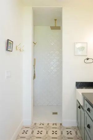 a bathroom with a granite countertop sink a bathtub a window and a mirror