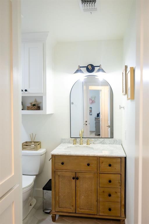 1132 Old Crawford Road Crawford, TX 76638 - Photo 32 of 40 a bathroom with a granite countertop toilet sink and mirror