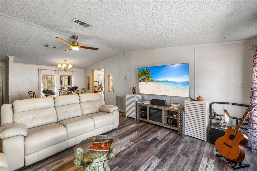 13205 Star Road Brooksville, FL 34613 - Photo 11 of 40 a living room with furniture and a flat screen tv