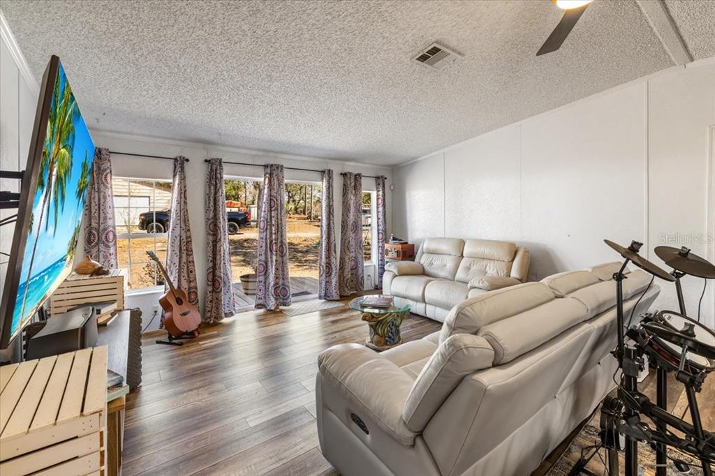 13205 Star Road Brooksville, FL 34613 - Photo 12 of 40 a living room with furniture and a flat screen tv