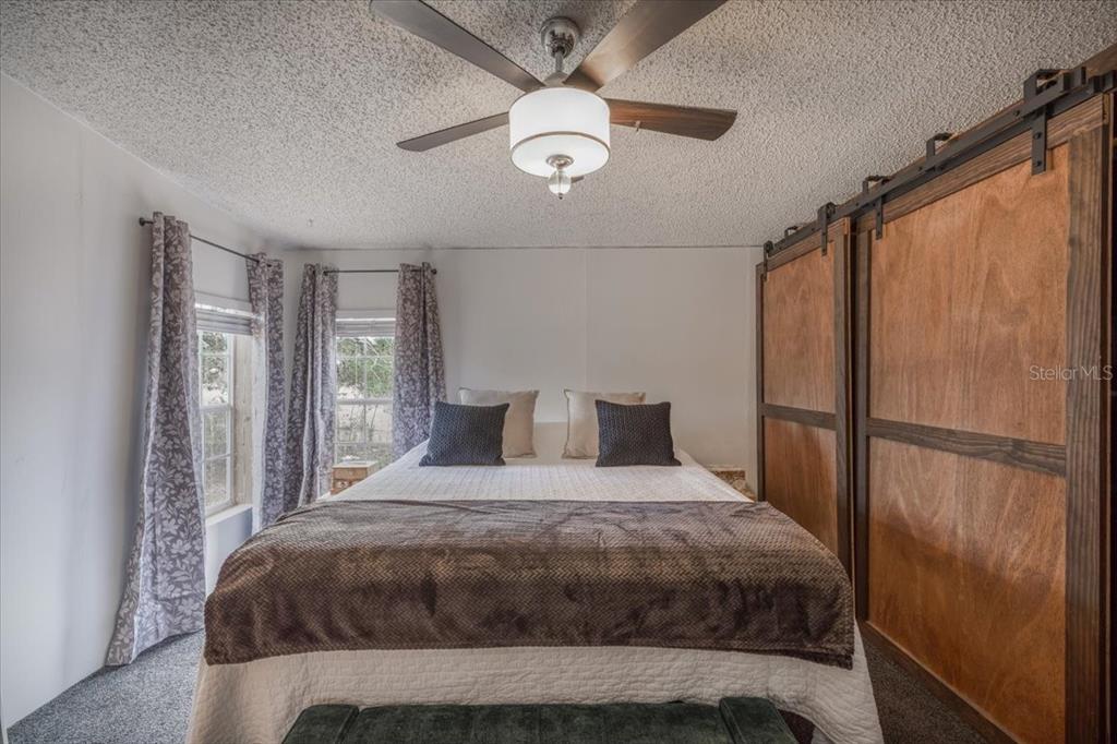 13205 Star Road Brooksville, FL 34613 - Photo 16 of 40 a bedroom with a bed and a large window