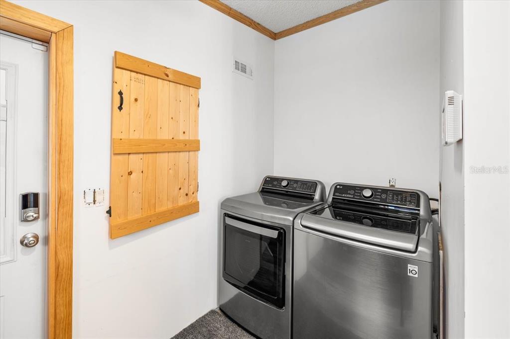 13205 Star Road Brooksville, FL 34613 - Photo 28 of 40 a kitchen with a stove and a refrigerator