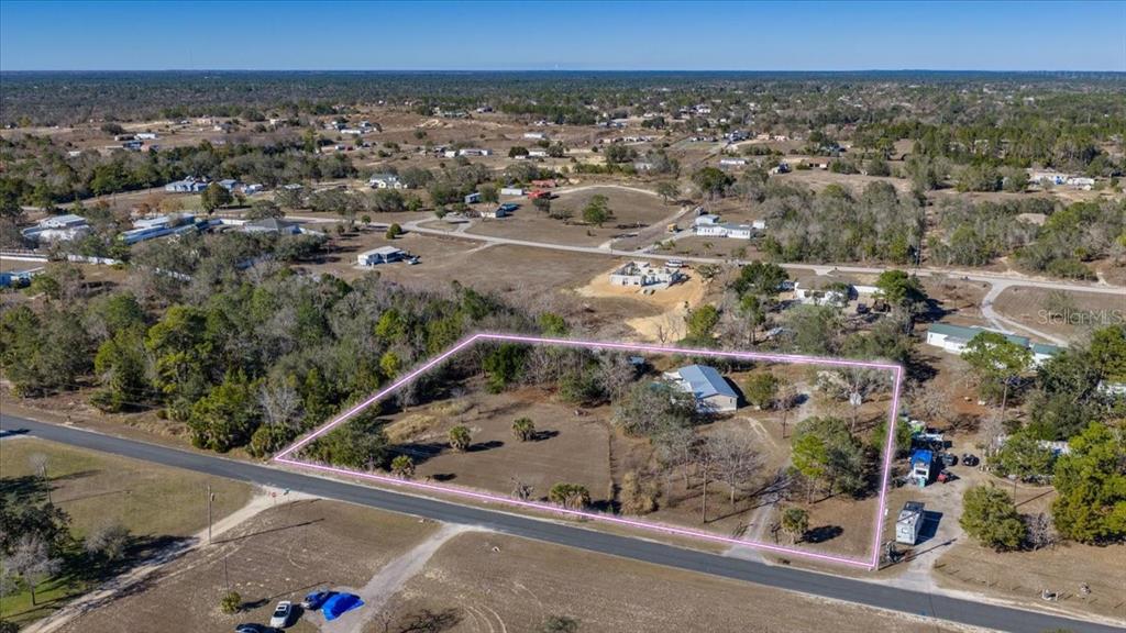 13205 Star Road Brooksville, FL 34613 - Photo 40 of 40 an aerial view of a house with a yard