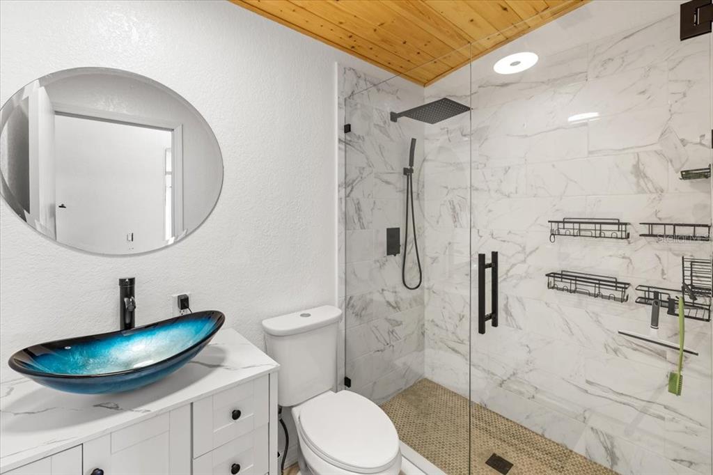 13205 Star Road Brooksville, FL 34613 - Photo 4 of 40 a bathroom with a sink a toilet and a mirror