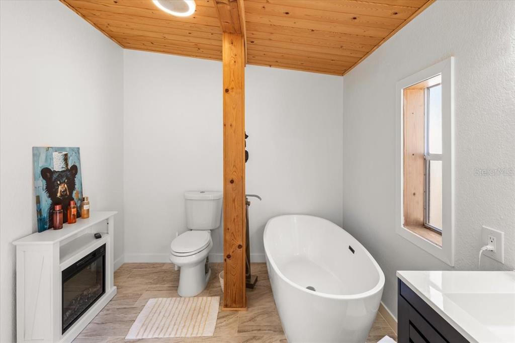 13205 Star Road Brooksville, FL 34613 - Photo 5 of 40 a bathroom with a sink a toilet and a mirror