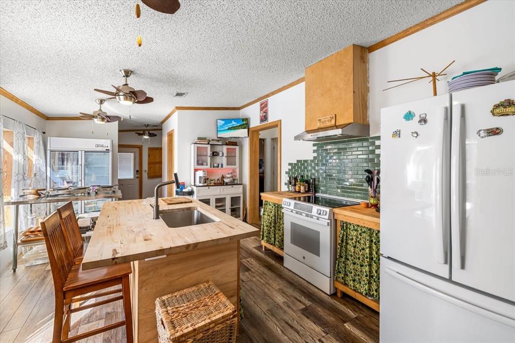 13205 Star Road Brooksville, FL 34613 - Photo 7 of 40 a kitchen with stainless steel appliances granite countertop a sink a stove and a refrigerator