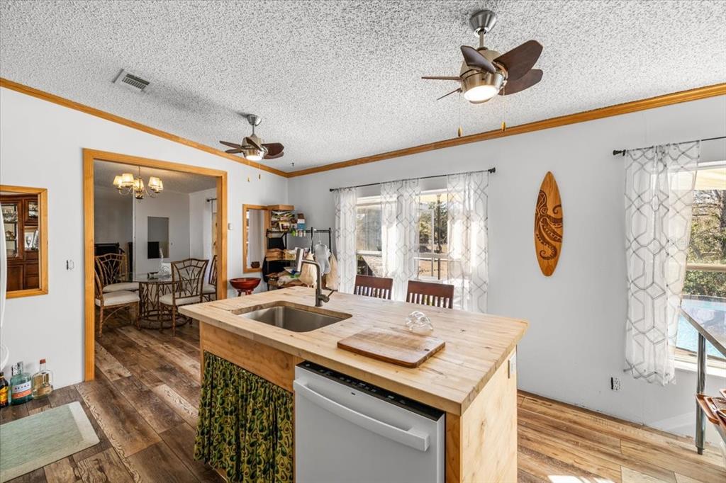 13205 Star Road Brooksville, FL 34613 - Photo 9 of 40 a kitchen with a table chairs and a chandelier