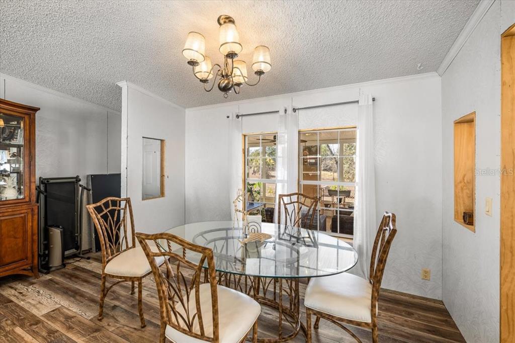 13205 Star Road Brooksville, FL 34613 - Photo 10 of 40 a view of a dining room with furniture window and outside view