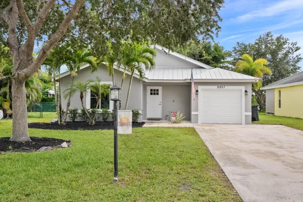 a front view of house with yard and green space
