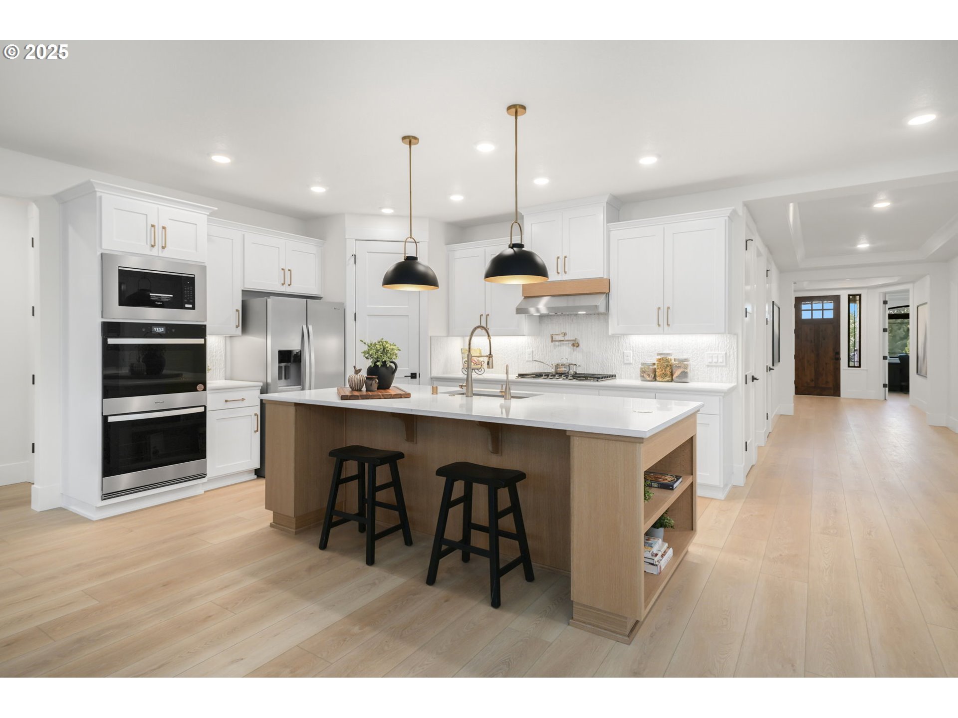 818 Northwest 173rd Street Ridgefield, WA 98642 - Photo 16 of 44 a kitchen with kitchen island stainless steel appliances a sink and a refrigerator