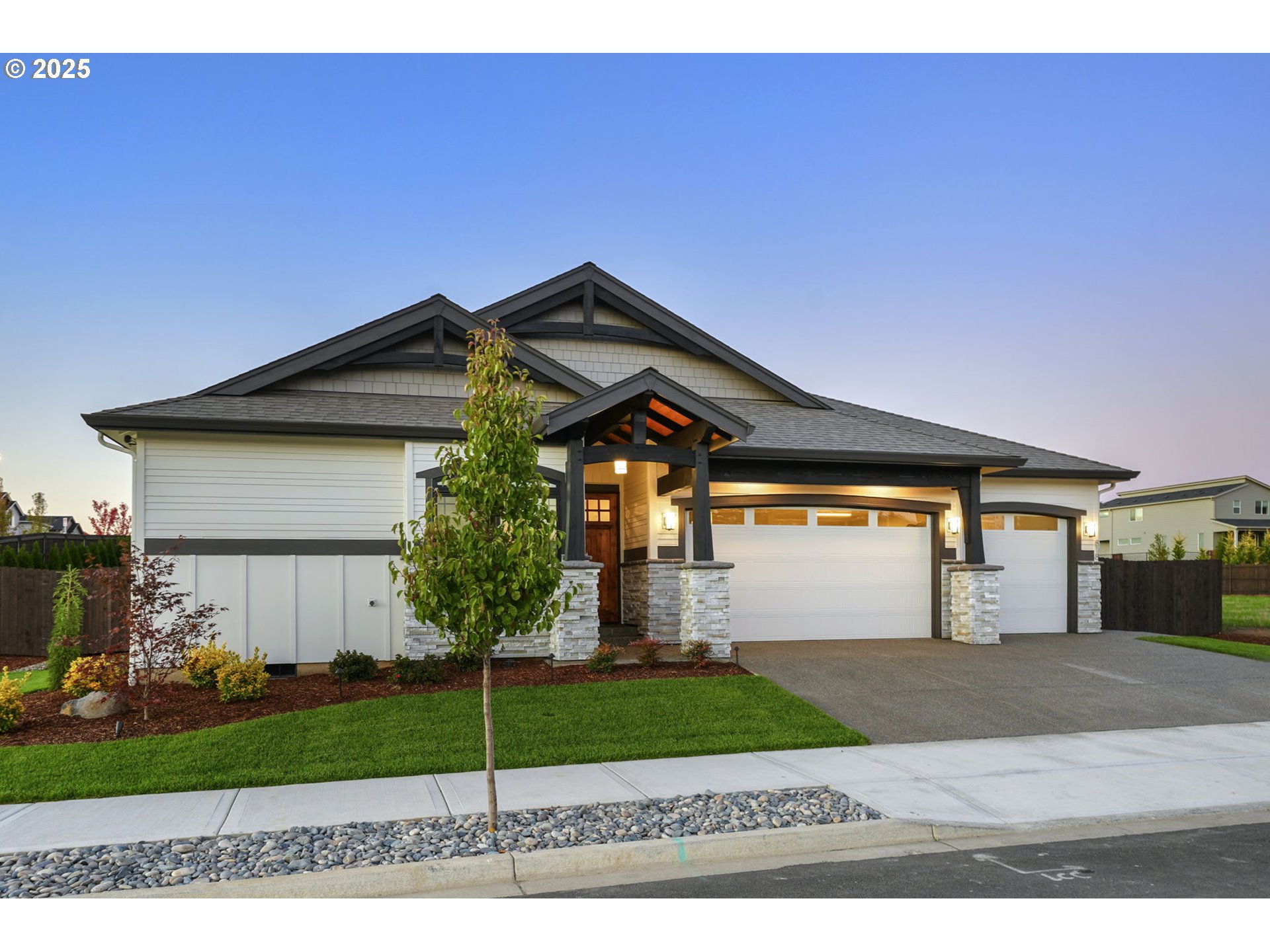 818 Northwest 173rd Street Ridgefield, WA 98642 - Photo 2 of 44 a front view of a house with a garden and garage