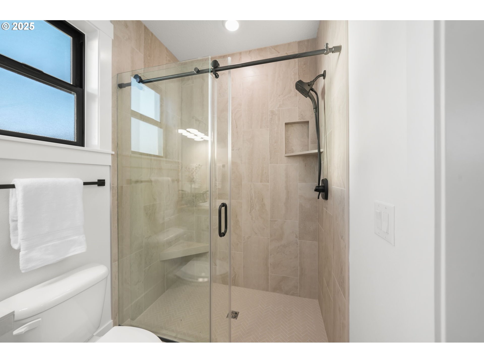 818 Northwest 173rd Street Ridgefield, WA 98642 - Photo 25 of 44 a bathroom with a shower and a glass door