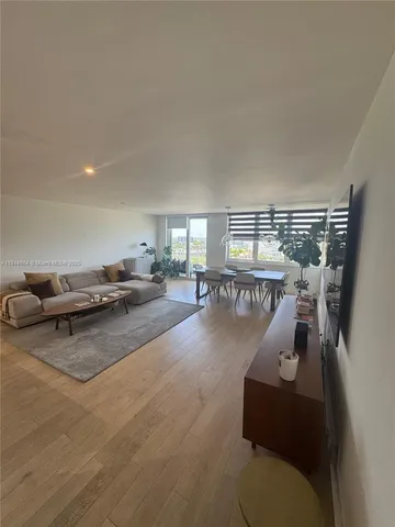 a living room with furniture and a gym machine