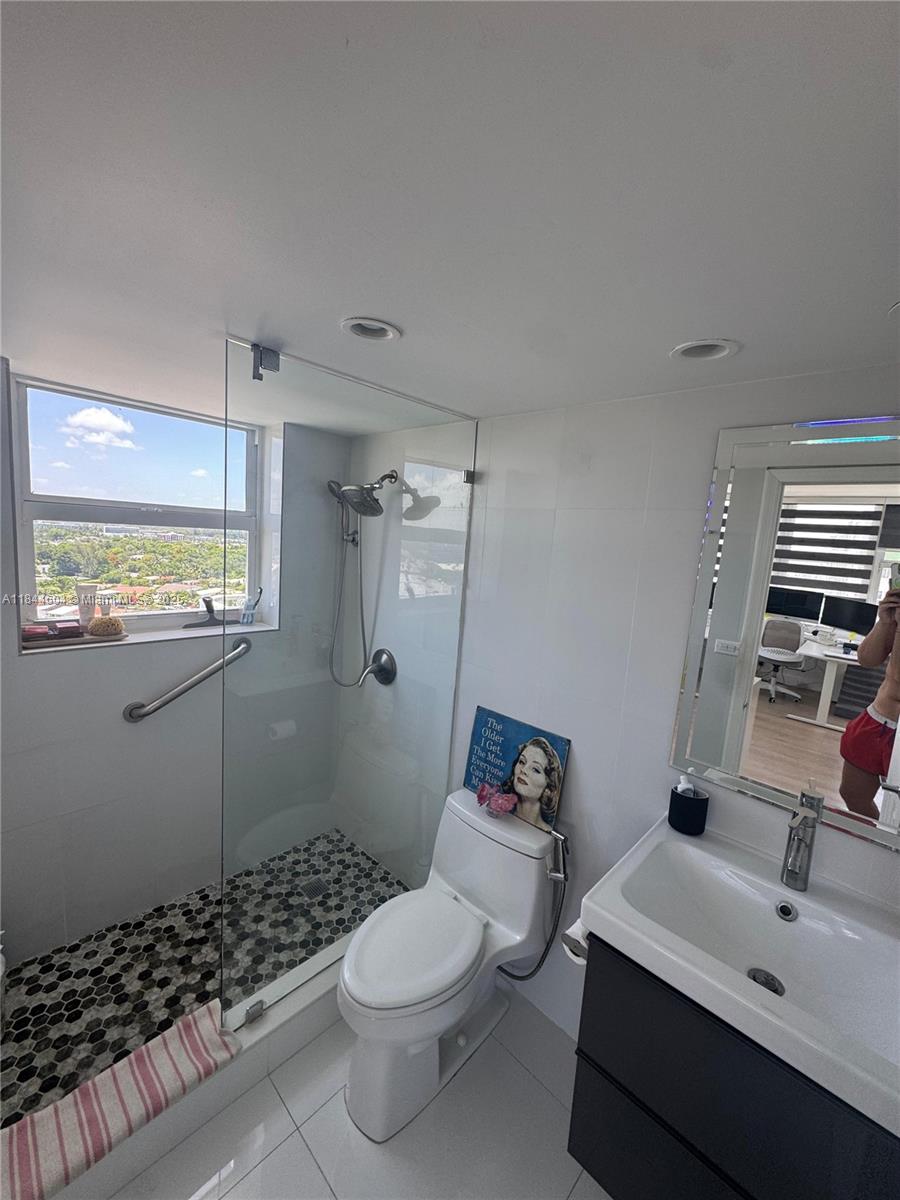 2150 Sans Souci Boulevard, Unit B1611 North Miami, FL 33181 - Photo 12 of 21 a bathroom with a sink toilet and shower