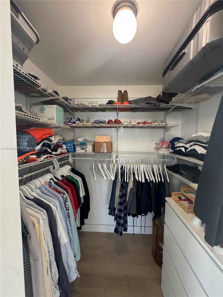 2150 Sans Souci Boulevard, Unit B1611 North Miami, FL 33181 - Photo 13 of 21 a view of walk in closet with clothes and shoes