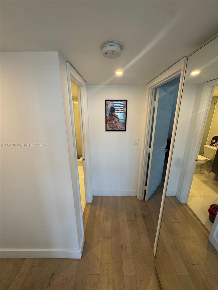 2150 Sans Souci Boulevard, Unit B1611 North Miami, FL 33181 - Photo 14 of 21 a view of a hallway with painted walls