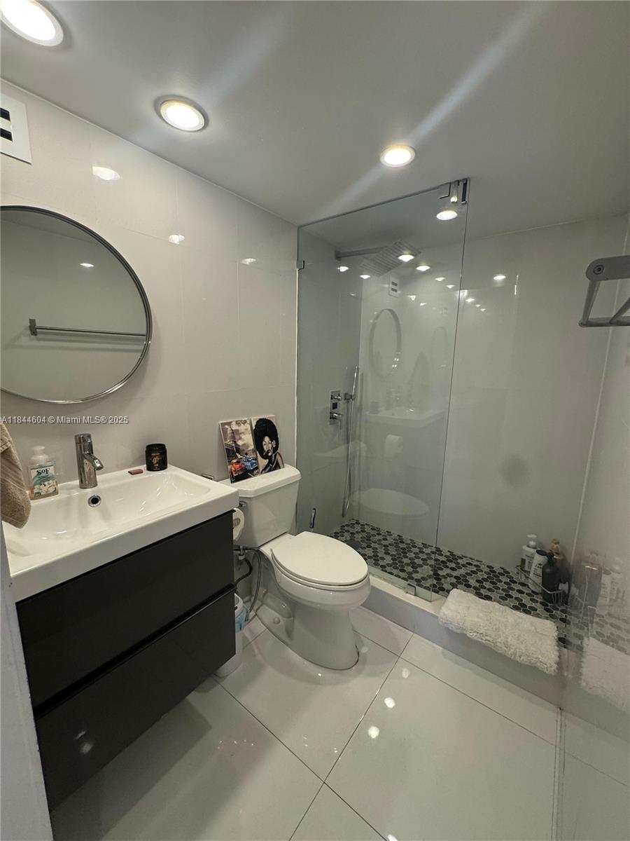2150 Sans Souci Boulevard, Unit B1611 North Miami, FL 33181 - Photo 15 of 21 a bathroom with a sink toilet and shower