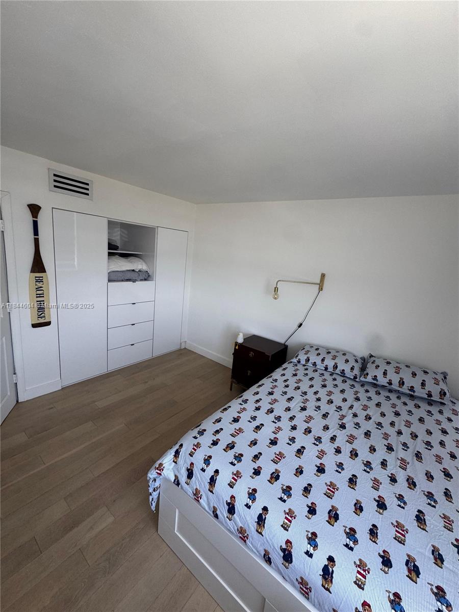 2150 Sans Souci Boulevard, Unit B1611 North Miami, FL 33181 - Photo 16 of 21 a bedroom with a bed and a black mirror