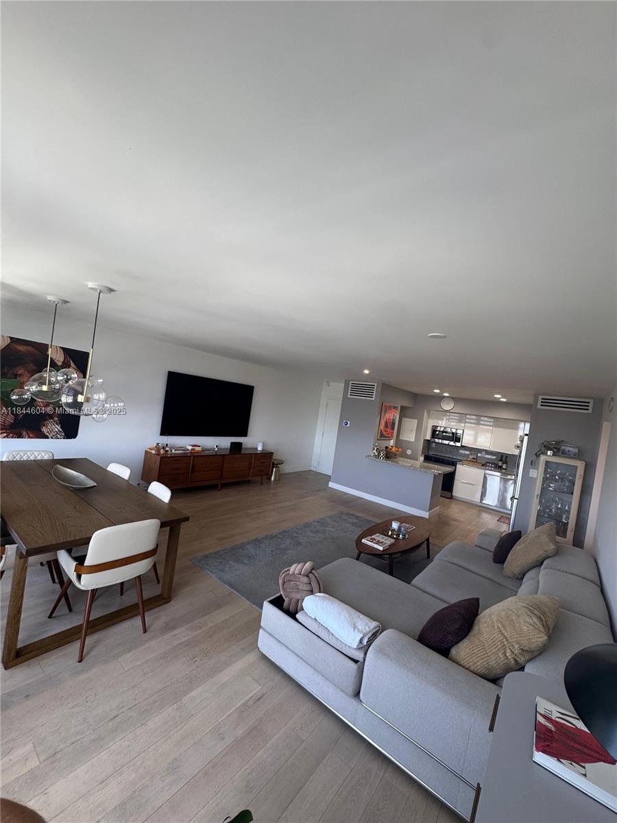 2150 Sans Souci Boulevard, Unit B1611 North Miami, FL 33181 - Photo 4 of 21 a living room with furniture and a flat screen tv