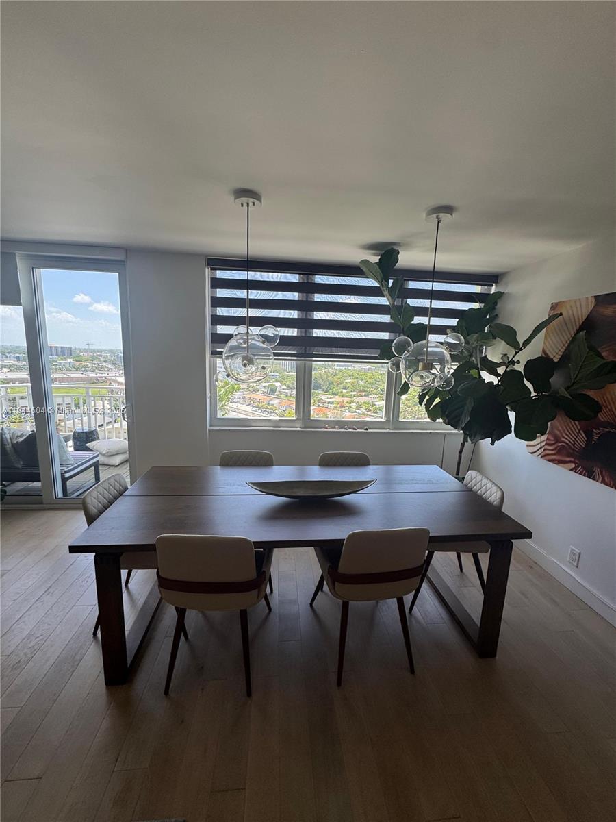 2150 Sans Souci Boulevard, Unit B1611 North Miami, FL 33181 - Photo 6 of 21 a view of a workspace with a table and chairs in a room