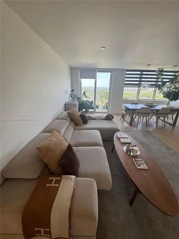 a living room with furniture and two window