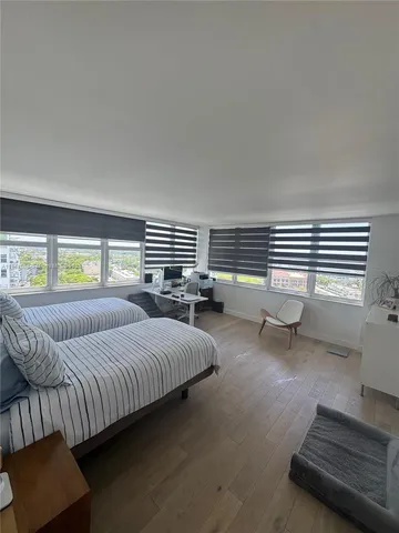 a bedroom with bed couch and window