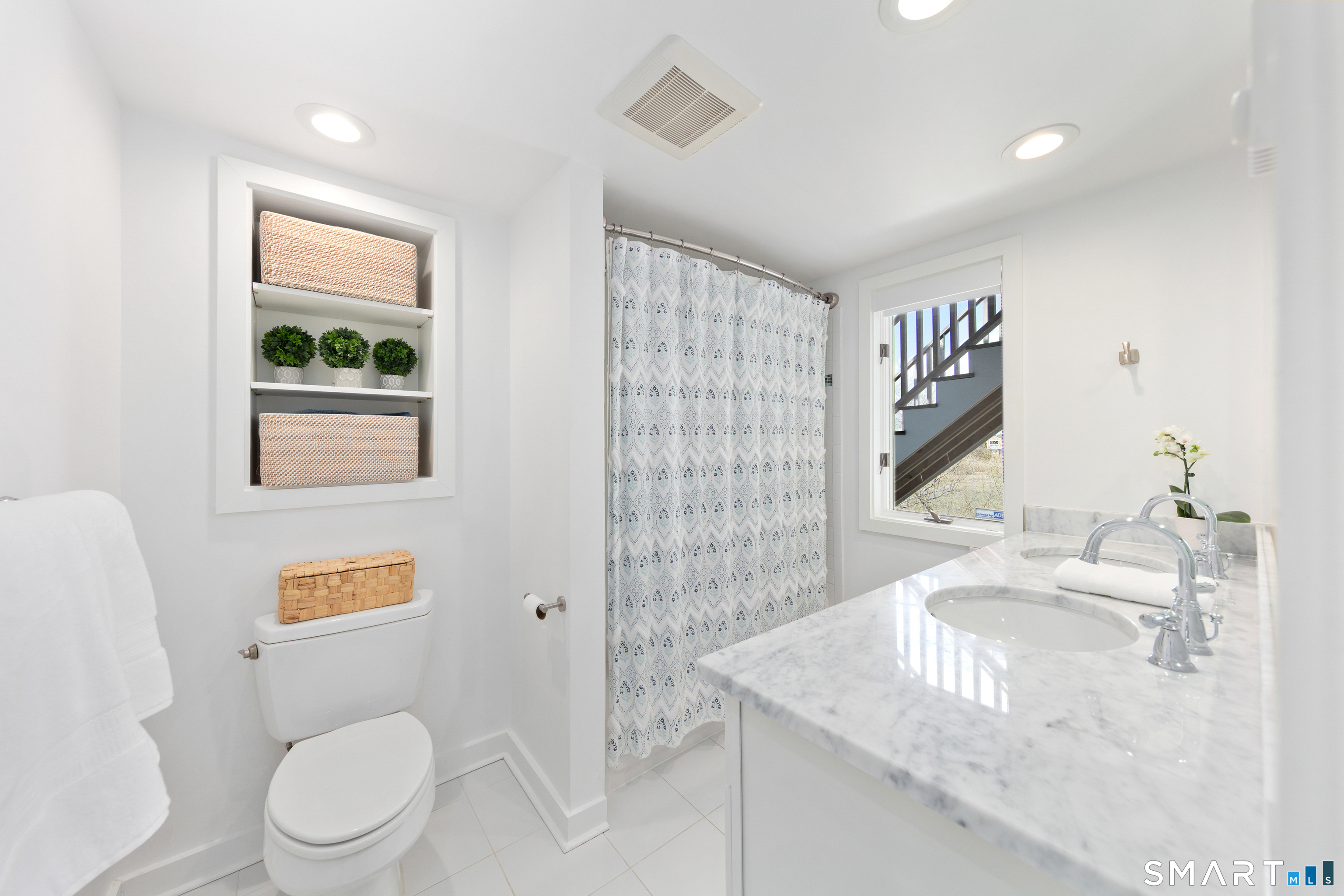 9 Marsh Road Westport, CT 06880 - Photo 27 of 39 a bathroom with a granite countertop sink a toilet and a mirror