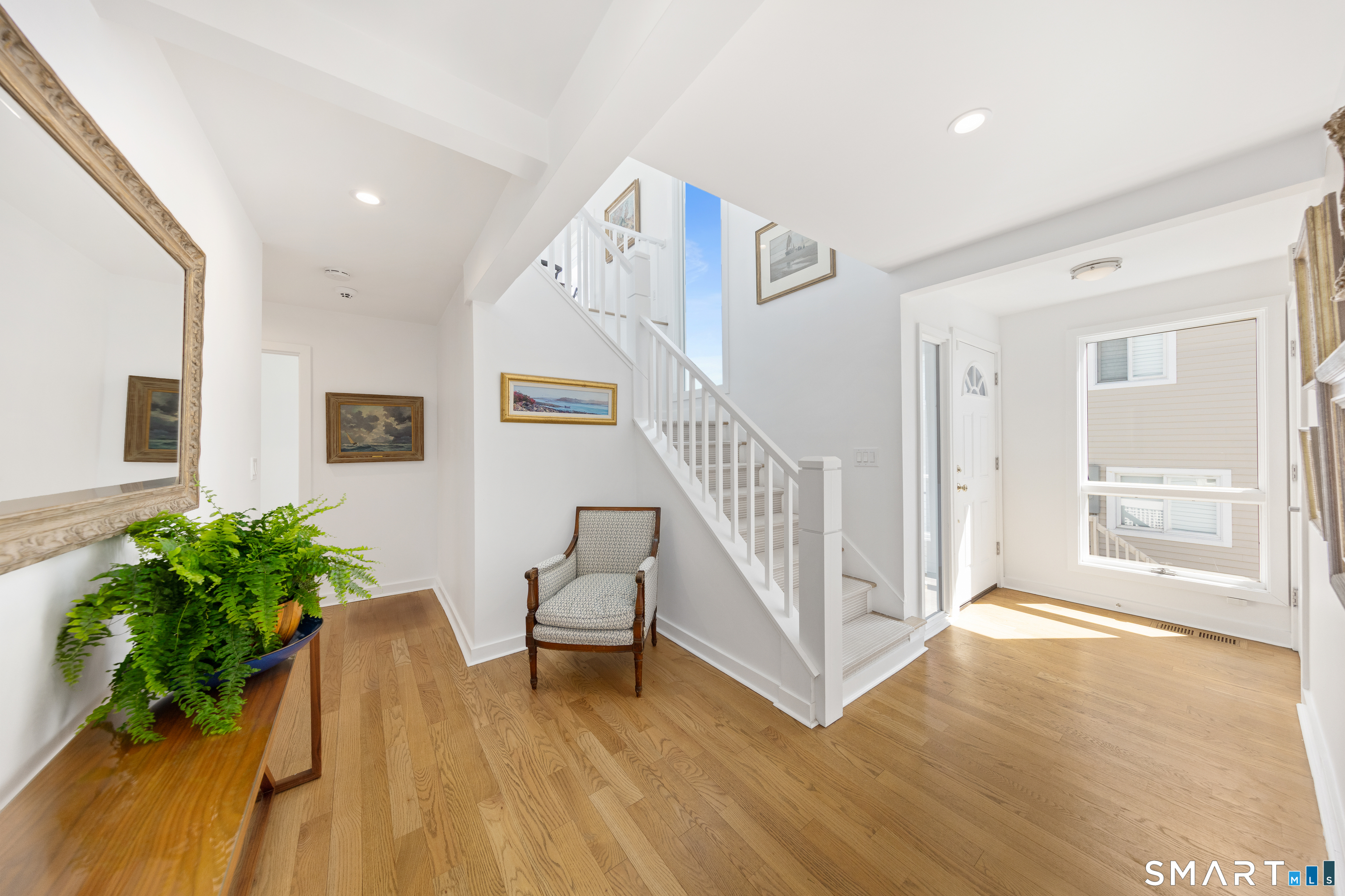 9 Marsh Road Westport, CT 06880 - Photo 3 of 39 a view of a hallway with wooden floor and a livingroom