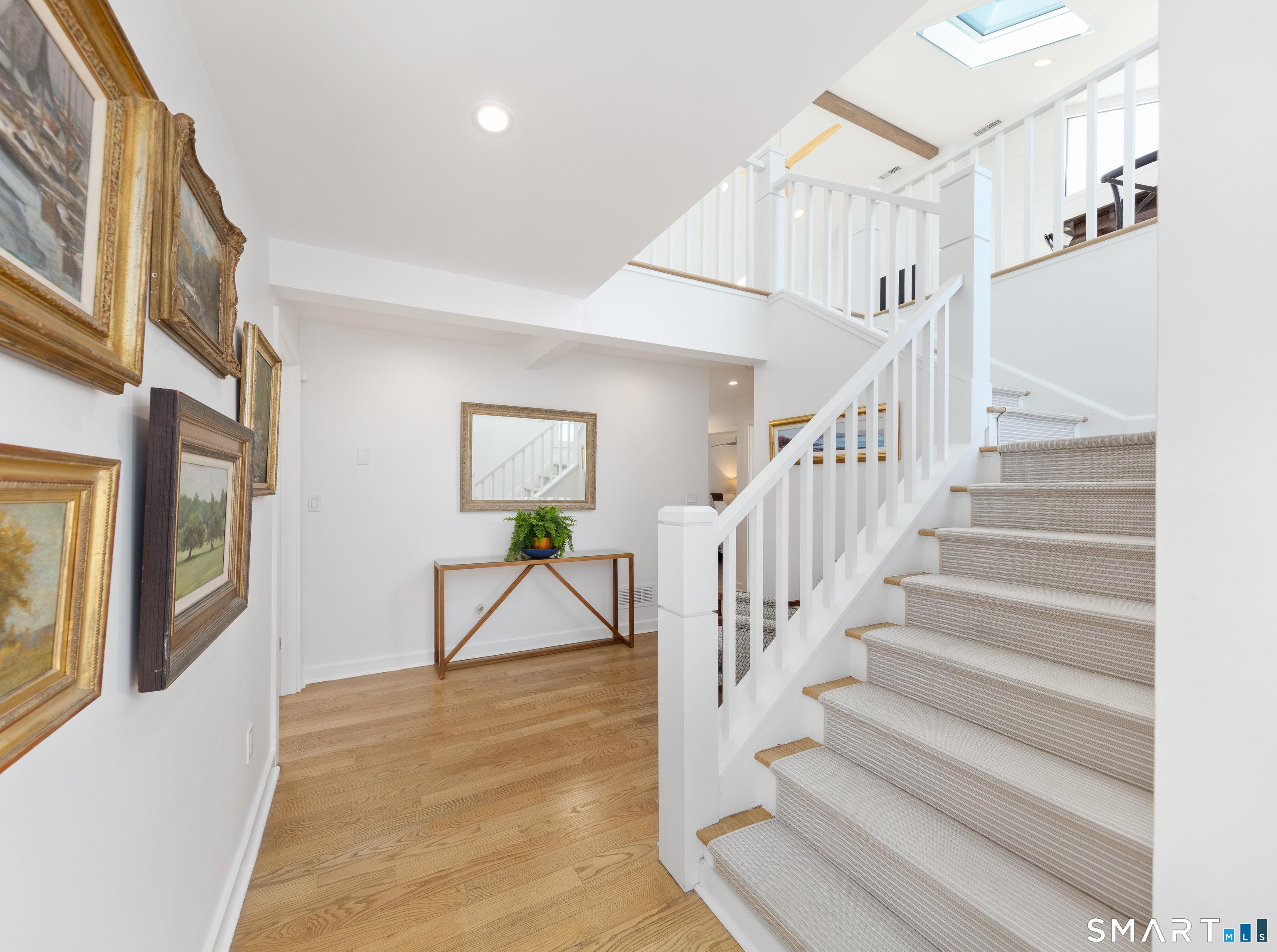 9 Marsh Road Westport, CT 06880 - Photo 4 of 39 a view of staircase with lots of frames and couches