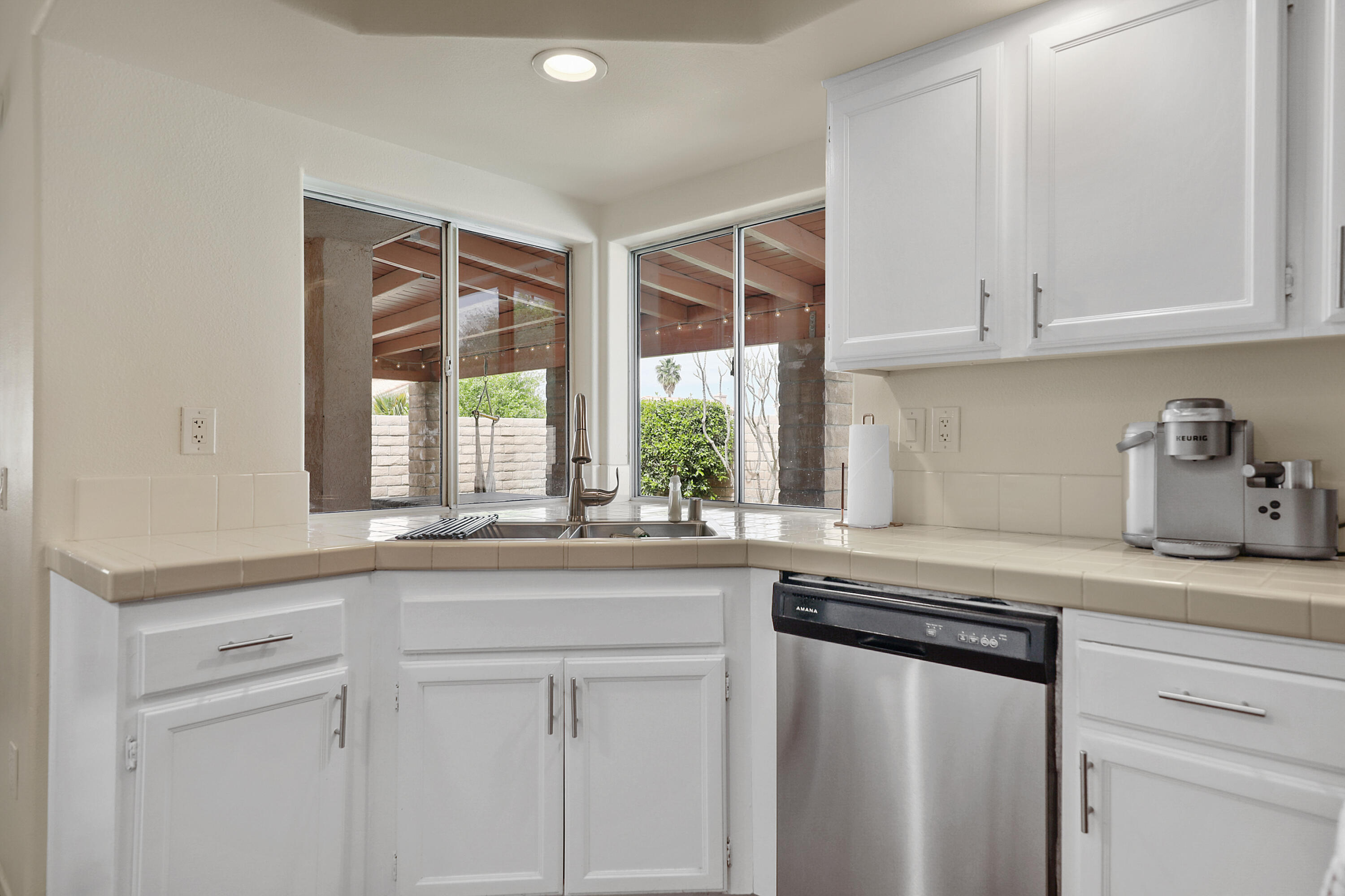 80380 Paseo Encanto Indio, CA 92201 - Photo 16 of 32 a kitchen with granite countertop white cabinets and a window