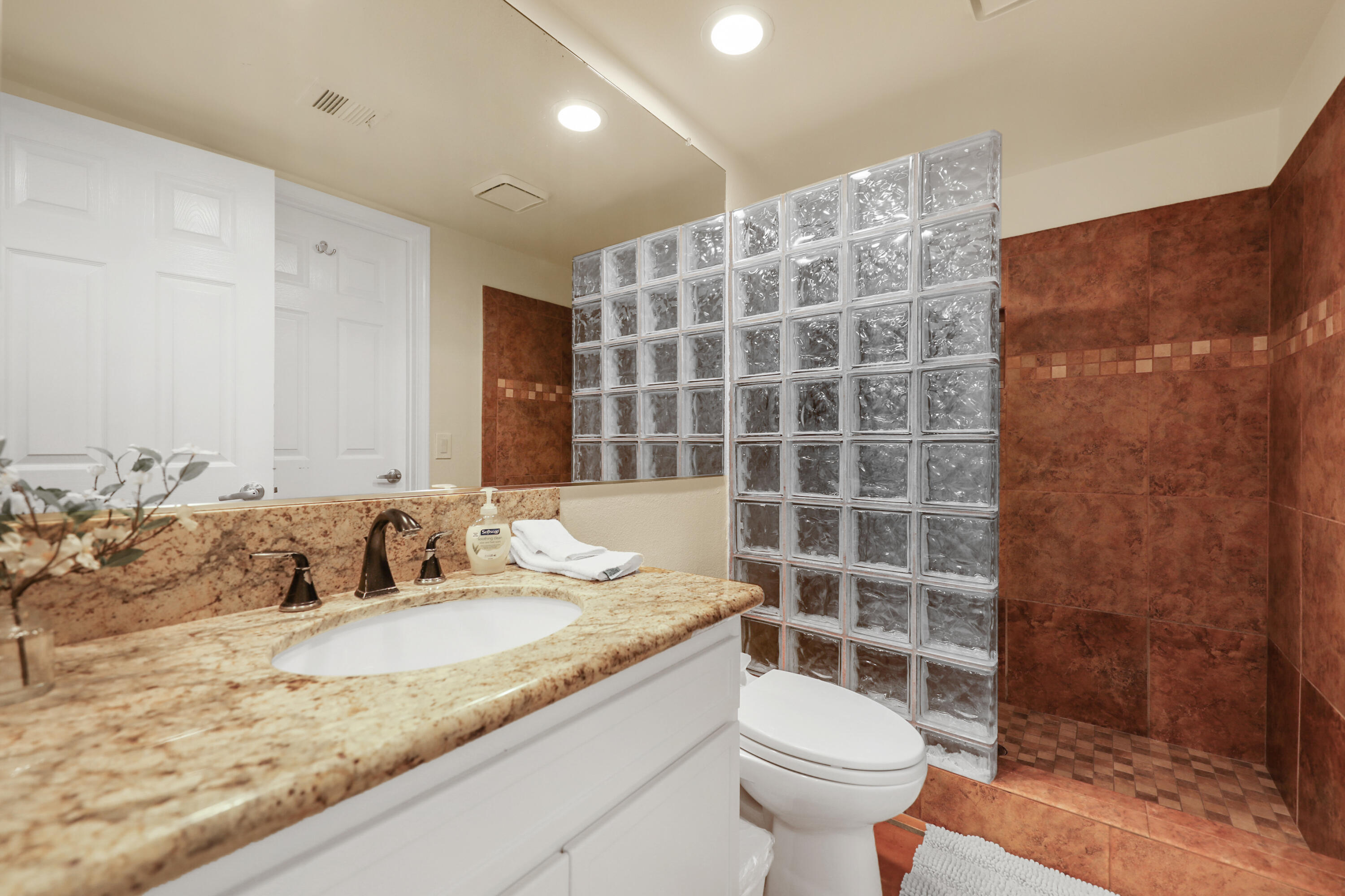 80380 Paseo Encanto Indio, CA 92201 - Photo 20 of 32 a bathroom with a granite countertop sink a toilet a mirror and shower