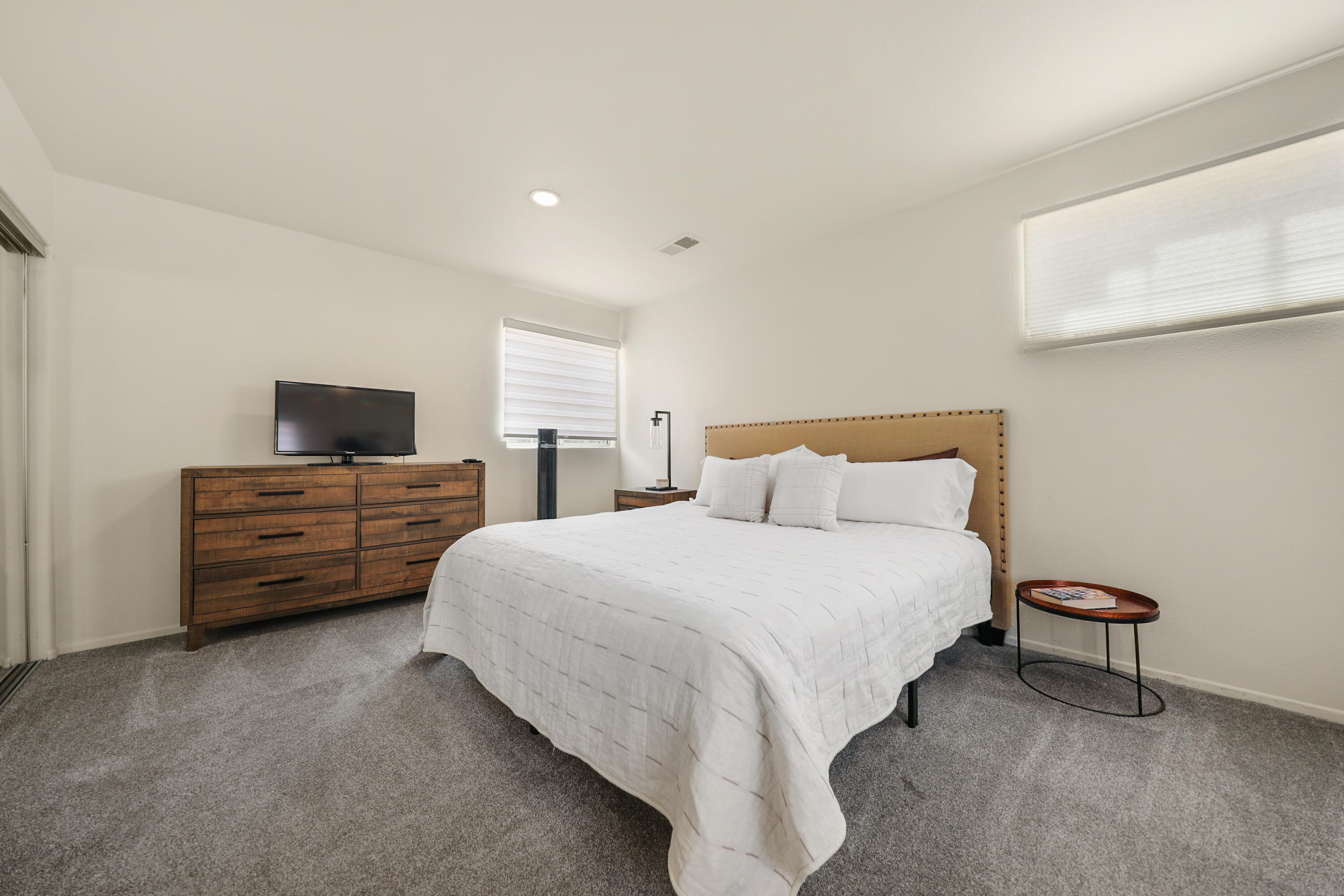 80380 Paseo Encanto Indio, CA 92201 - Photo 24 of 32 a bedroom with a bed a couch and a flat screen tv