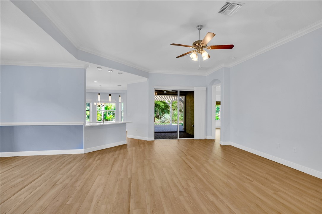 239 11th Square Southwest Vero Beach, FL 32962 - Photo 11 of 36 wooden floor in an empty room with a window