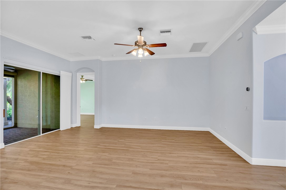 239 11th Square Southwest Vero Beach, FL 32962 - Photo 13 of 36 a view of a room with wooden floor and ceiling fan