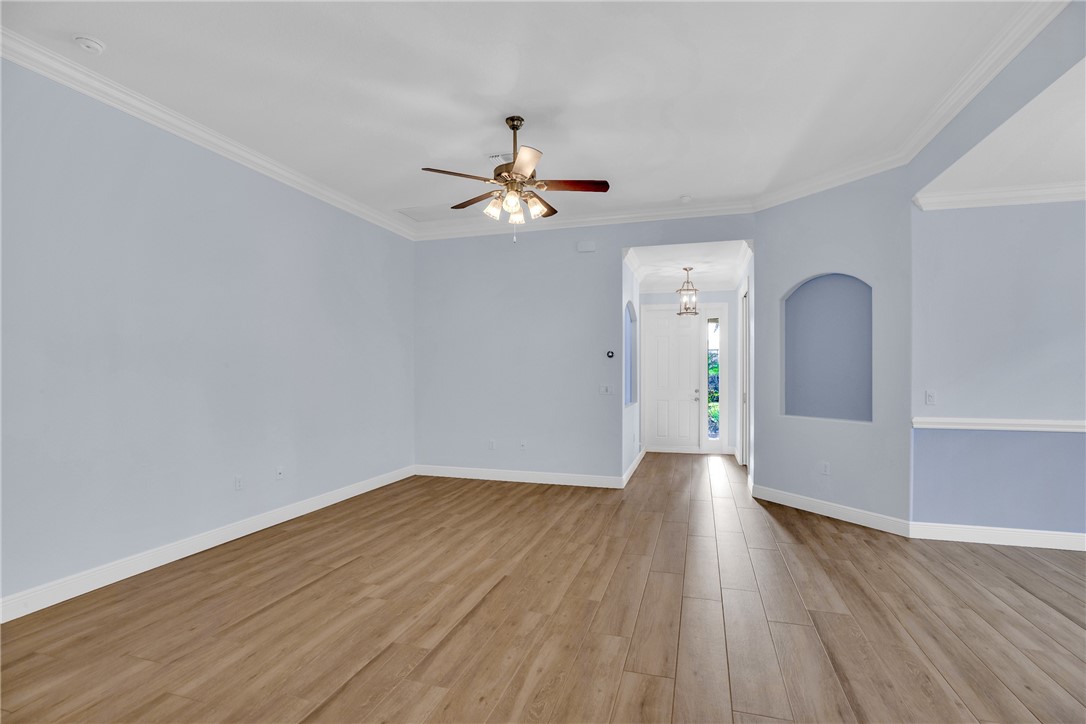 239 11th Square Southwest Vero Beach, FL 32962 - Photo 14 of 36 wooden floor in an empty room with a window