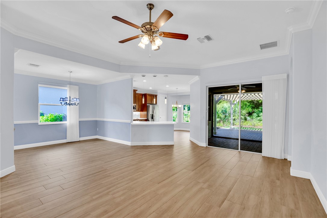 239 11th Square Southwest Vero Beach, FL 32962 - Photo 16 of 36 a view of empty room with wooden floor and fan