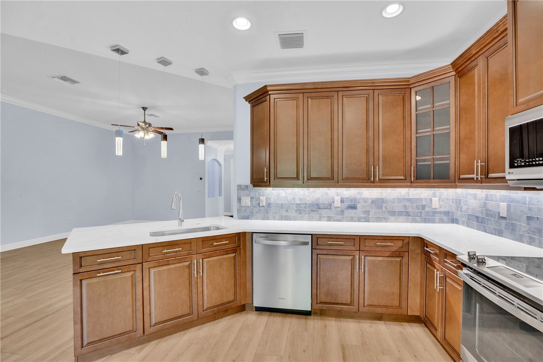 239 11th Square Southwest Vero Beach, FL 32962 - Photo 19 of 36 a kitchen with a sink stove and cabinets