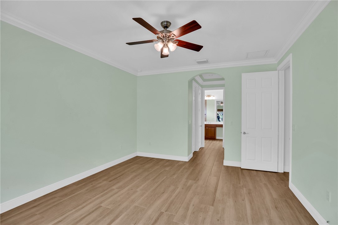 239 11th Square Southwest Vero Beach, FL 32962 - Photo 24 of 36 an empty room with wooden floor and ceiling fan