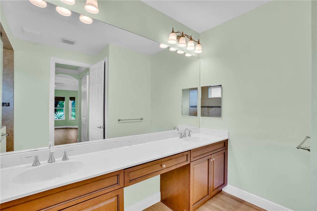 239 11th Square Southwest Vero Beach, FL 32962 - Photo 27 of 36 a bathroom with a sink double vanity and a mirror