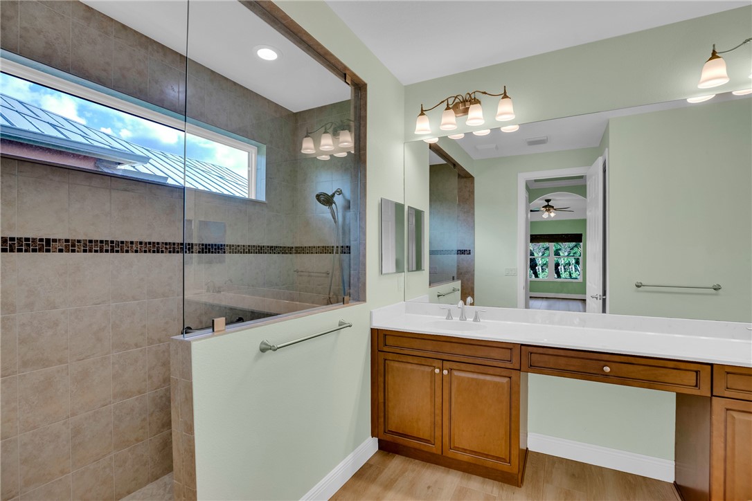 239 11th Square Southwest Vero Beach, FL 32962 - Photo 28 of 36 a bathroom with a sink and a mirror