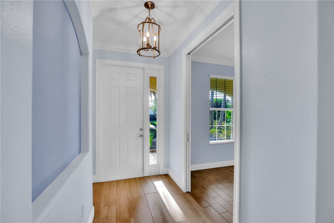239 11th Square Southwest Vero Beach, FL 32962 - Photo 10 of 36 wooden floor in an empty room with a window