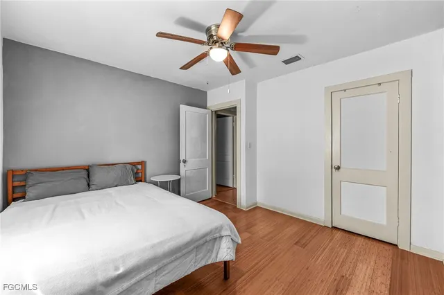 a bedroom with a bed and a ceiling fan