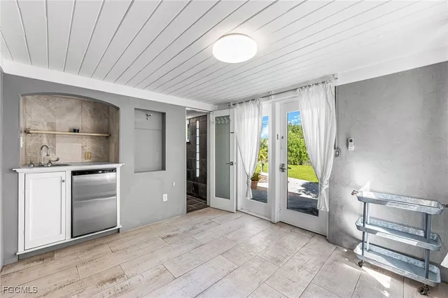 a kitchen with a refrigerator and white cabinets